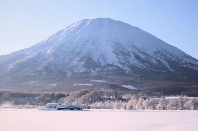 Snowy farmland small houses mount yotei winter